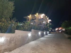 a house with lights on the side of a street at Hotel Afrodite in Dhërmi