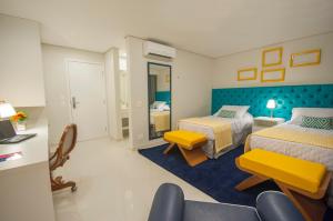Cama ou camas em um quarto em Doral Guarujá