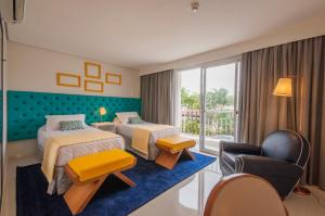 Cama ou camas em um quarto em Doral Guarujá