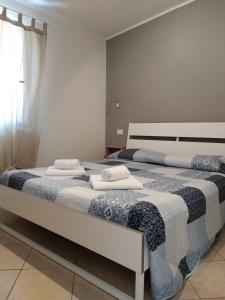 Dos camas en un dormitorio con toallas. en Quirino Residence, en Gaeta