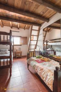 1 dormitorio con 2 literas en una habitación con techos de madera en Monte dos Pintos en Arronches