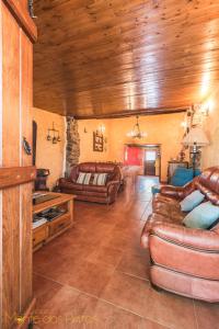 a living room with leather furniture and a wooden ceiling at Monte dos Pintos in Arronches +21 photos