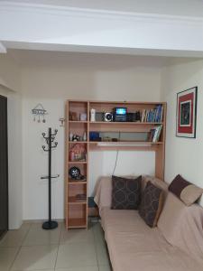 a living room with a couch and a book shelf at Apartment ,,The Mall Athens" in Athens
