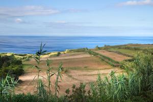 a golf course with the ocean in the background at Casa Rotas a Nordeste in Nordeste +9 photos