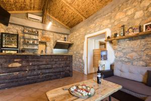 a room with a table and a stone wall at Krk Patak in Vrh