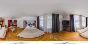 a bedroom with a bed and a flat screen tv at Alpina home in Rosenheim
