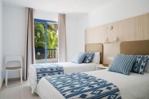 Postel nebo postele na pokoji v ubytování Aparthotel Pierre & Vacances Mallorca Cecilia + 37 fotografií