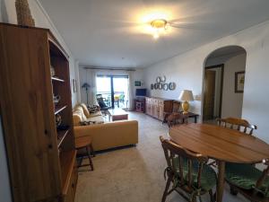 a living room with a table and a couch at Dorasal Solo Familias Serviplaya in Playa de Xeraco