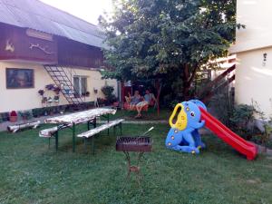 a playground with a slide and a grill and a bench at Casa Verde in Săsciori