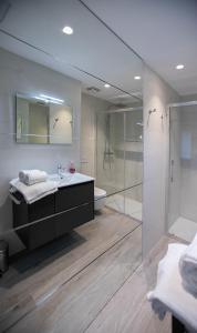 a bathroom with a sink and a shower and a mirror at APARTAMENTOS TURISTICOS - PAPEL ARMADO - Calle Caldereros 33 in Tudela +23 photos