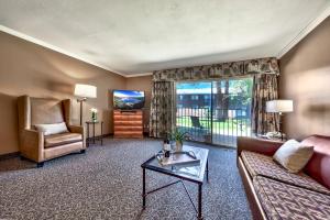 a living room with a couch and a tv at Forest Suites Resort at the Heavenly Village in South Lake Tahoe