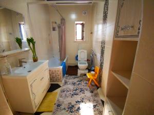 a small bathroom with a sink and a toilet at Kurak Homestay in Bishkek