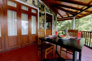 a dining room with a table with fruit on it at Blue Ribbon Homestay in Ella