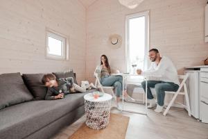 a group of people sitting in a living room at Raceway Baltic cabins in Silakrogs