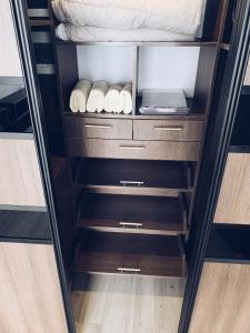 a closet with wooden drawers and a bed at Room1402 in Odesa +36 photos