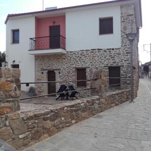 two birds sitting on the ledge of a building at To petrino holidays house in Metangítsion