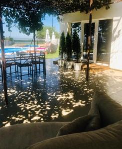 eine Terrasse mit einem Tisch, Stühlen und einem Pool in der Unterkunft Serendipity in Smederevo