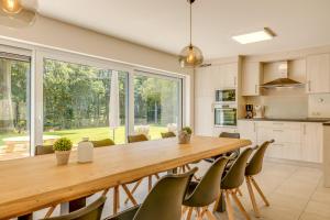 a kitchen with a large wooden table and chairs at Maison LoKaKo in Waimes