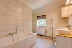 a bathroom with a tub and a sink at Maison LoKaKo in Waimes +37 photos