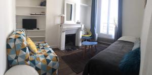 a living room with a couch and a fireplace at Joli 2 pièces # Paris 14eme in Paris