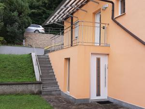 a staircase leading to a house with a balcony at A Spacious 3 Bedroom Apartment in Bad Abbach/Regensburg in Bad Abbach