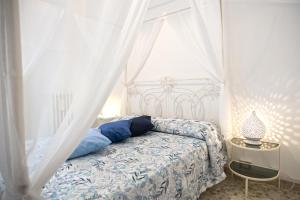 a bedroom with a bed with a canopy at Il Segnalibro B&B in Alberobello