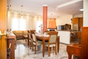 a kitchen and dining room with a table and chairs at Veta's spacious central apartment in Serres