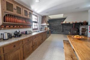 a large kitchen with wooden cabinets and a counter top at Casa do Monte - Douro in Baião