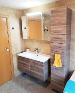 a bathroom with a sink and a mirror at A Spacious 3 Bedroom Apartment in Bad Abbach/Regensburg in Bad Abbach