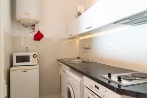a small kitchen with a sink and a microwave at Beachfront apartment Promenade Des Anglais in Nice