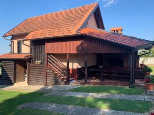 a house with a pitched roof with a deck at Vila Pajo in Varaždinske Toplice