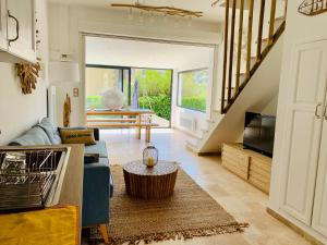 a living room with a couch and a tv at Maison en front de mer sur la plage de portissol in Sanary-sur-Mer