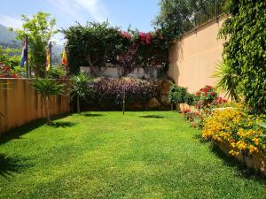 a garden with colorful flowers and a fence at Villa Santa Barbara in Cefalù