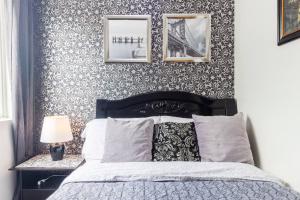 a bedroom with a bed and two pictures on the wall at Trees Residences SMDC by Jhoms in Manila +24 photos