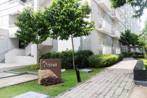 a tree in front of a building at Trees Residences SMDC by Jhoms in Manila