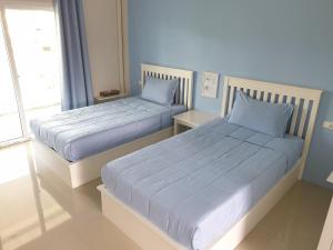 Ein Bett oder Betten in einem Zimmer der Unterkunft Vanilla Ville Resort