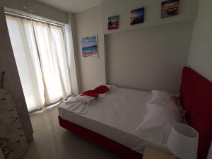 a bedroom with a white bed and two windows at Milla Lux 3 in Paralia Katerinis
