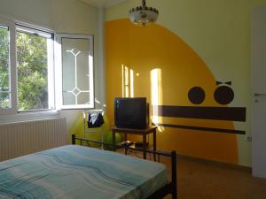 a bedroom with a bed and a tv in it at Sun and Sea in Souvala