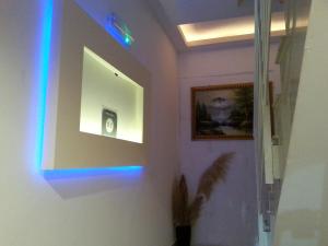 a hallway with a blue light on a wall at White Stallion in Mellieħa