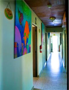 an empty hallway with a painting on the wall at Hotel Oasis in San Salvador