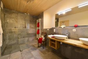 a bathroom with two sinks and a shower at Landhof Müller in Wertach +55 photos