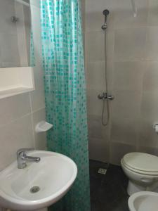 a bathroom with a shower with a sink and a toilet at Ezeiza Home in Ezeiza +22 photos
