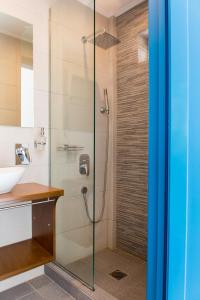 a shower with a glass door in a bathroom at Meltemi Studios in Megalochori +21 photos
