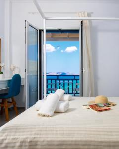a bedroom with a bed with a view of the ocean at Meltemi Studios in Megalochori