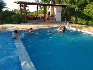 un groupe de personnes dans une piscine dans l'établissement Casa Schneider, à Gravatá
