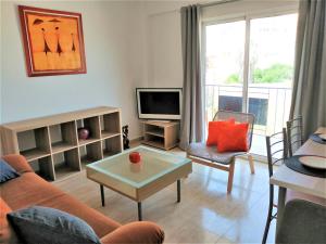 a living room with a couch and a tv at Unigue Design Apartment, Gandia in Gandía