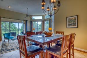 a dining room with a wooden table and chairs at Cypress Point Condominiums at Craft Farms #306B in Gulf Shores