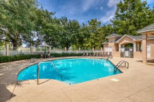 a swimming pool in a yard with a house at Cypress Point Condominiums at Craft Farms #306B in Gulf Shores