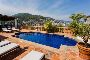 a swimming pool on the roof of a house at Hacienda San Angel in Puerto Vallarta