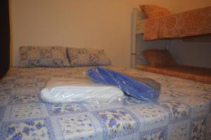 a bed with two plastic bags on top of it at Apartamento para 7 pessoas próximo a Basílica in Aparecida